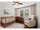 Comfortable Bedroom with a crib, dresser, soft rug, and plenty of natural light at 3843 Lake Se Dr, Smyrna, GA 30082