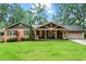 Charming brick home featuring a spacious covered porch with a gable and an attached two car garage at 3843 Lake Se Dr, Smyrna, GA 30082