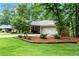 Charming brick home featuring a spacious covered porch with a gable and attached two car garage at 3843 Lake Se Dr, Smyrna, GA 30082