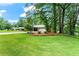 Lush green lawn and mature trees enhance the curb appeal of this well-maintained property at 3843 Lake Se Dr, Smyrna, GA 30082