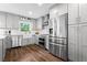 Updated kitchen features stainless steel appliances, subway tile backsplash, and grey cabinetry at 3843 Lake Se Dr, Smyrna, GA 30082