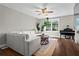 Inviting living room featuring a large sectional sofa, piano, and natural light at 3843 Lake Se Dr, Smyrna, GA 30082