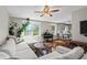 Open concept living room featuring a large sectional sofa, piano, and views to a modern kitchen at 3843 Lake Se Dr, Smyrna, GA 30082