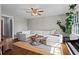 Spacious living room featuring a large sectional sofa, piano, and hardwood floors at 3843 Lake Se Dr, Smyrna, GA 30082