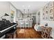 Open living room featuring hardwood floors, a piano, seating, and views of the kitchen at 3843 Lake Se Dr, Smyrna, GA 30082