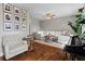 Inviting living room featuring a large sectional sofa, piano, hardwood floors, and framed wall art at 3843 Lake Se Dr, Smyrna, GA 30082