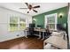 Bright home office featuring natural light, hardwood floors, and ample desk space for working from home at 3843 Lake Se Dr, Smyrna, GA 30082