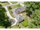 Aerial view of the home with manicured lawn, cozy backyard area, and a side driveway at 402 Johannah Sw Pl, Lilburn, GA 30047