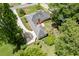 Birds eye view of the home with a long driveway leading to the residence and a landscaped backyard at 402 Johannah Sw Pl, Lilburn, GA 30047