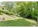 The backyard has a terraced yard with mature trees at 402 Johannah Sw Pl, Lilburn, GA 30047