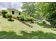 The backyard has terraced yard, grass and mature trees at 402 Johannah Sw Pl, Lilburn, GA 30047
