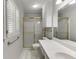 This bathroom features a white vanity, and a shower with glass doors at 402 Johannah Sw Pl, Lilburn, GA 30047