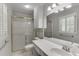 This bathroom has tile floors, a shower with a glass door, and a white vanity at 402 Johannah Sw Pl, Lilburn, GA 30047