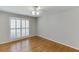 Comfortable bedroom featuring hardwood floors and bright, shuttered windows at 402 Johannah Sw Pl, Lilburn, GA 30047