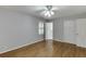 This bedroom has hardwood floors, neutral colored walls, a window with blinds and a ceiling fan at 402 Johannah Sw Pl, Lilburn, GA 30047
