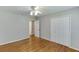 Spacious bedroom featuring hardwood floors and large closet at 402 Johannah Sw Pl, Lilburn, GA 30047