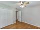 Bedroom featuring hardwood floors, ceiling fan and closet at 402 Johannah Sw Pl, Lilburn, GA 30047