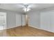 This bedroom features hardwood floors, a ceiling fan, and access to the bathroom at 402 Johannah Sw Pl, Lilburn, GA 30047