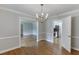 Open-concept dining room with hardwood floors leading to the living room and kitchen at 402 Johannah Sw Pl, Lilburn, GA 30047
