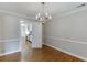 Charming dining room with hardwood floors, neutral walls, and a classic chandelier at 402 Johannah Sw Pl, Lilburn, GA 30047