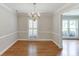 Traditional dining room with hardwood floors, wainscoting, and a chandelier at 402 Johannah Sw Pl, Lilburn, GA 30047