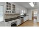 Kitchen featuring white cabinets, granite counters, stainless appliances and tile backsplash at 402 Johannah Sw Pl, Lilburn, GA 30047
