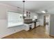 Bright kitchen featuring white cabinets, granite countertops and stainless steel appliances at 402 Johannah Sw Pl, Lilburn, GA 30047