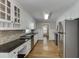 Spacious kitchen with tiled backsplash, stainless appliances and granite countertops at 402 Johannah Sw Pl, Lilburn, GA 30047