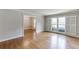 Open-concept living room with gleaming hardwood floors, white trim, and lots of natural light at 402 Johannah Sw Pl, Lilburn, GA 30047