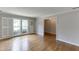Elegant living room with hardwood floors, large windows, and classic shutters for natural light at 402 Johannah Sw Pl, Lilburn, GA 30047