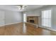 Inviting living room with brick fireplace, hardwood floors, and large windows at 402 Johannah Sw Pl, Lilburn, GA 30047