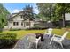 Backyard featuring a custom gravel area, lounge chairs, lush green grass, and a fire pit at 622 Seminole Ne Ave, Atlanta, GA 30307