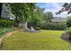 Spacious backyard featuring a well-maintained lawn, garden shed, lounge chairs, and established trees at 622 Seminole Ne Ave, Atlanta, GA 30307