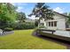 Well-manicured backyard featuring lush green grass, wooden deck, and a neatly landscaped garden at 622 Seminole Ne Ave, Atlanta, GA 30307