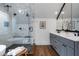 Modern bathroom with glass enclosed shower, double sink vanity with gray cabinets, and wood-look tile flooring at 622 Seminole Ne Ave, Atlanta, GA 30307