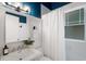 Charming bathroom features blue accent wall, white tile, and stylish light fixture at 622 Seminole Ne Ave, Atlanta, GA 30307