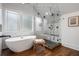 Modern bathroom featuring a soaking tub, glass-enclosed shower, and wood-look tile flooring at 622 Seminole Ne Ave, Atlanta, GA 30307