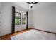 Bright bedroom featuring hardwood floors, large windows, neutral rug, and ceiling fan at 622 Seminole Ne Ave, Atlanta, GA 30307