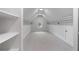 Spacious walk-in closet with neutral carpeting, white trim, and custom shelving for optimal storage at 622 Seminole Ne Ave, Atlanta, GA 30307