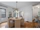 Bright dining room features stylish light fixture and seating for six around a wooden table at 622 Seminole Ne Ave, Atlanta, GA 30307