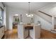 Bright dining room features stylish light fixture, seating for six, and staircase at 622 Seminole Ne Ave, Atlanta, GA 30307