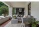 Cozy front porch setup with cushioned seating, textured rug, and serene outdoor views at 622 Seminole Ne Ave, Atlanta, GA 30307