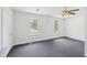 Bright bedroom with two windows, neutral walls, and a ceiling fan with light fixture at 742 Redland Dr, Jonesboro, GA 30238