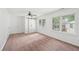 Bedroom featuring neutral carpet, sliding closet doors, and windows for ample light at 742 Redland Dr, Jonesboro, GA 30238
