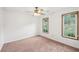 Bedroom with neutral walls, plush carpet, and large windows for ample natural light at 742 Redland Dr, Jonesboro, GA 30238