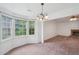 A view into the Dining Room with bay windows and into the Living Room with a fireplace at 742 Redland Dr, Jonesboro, GA 30238