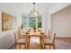 Bright dining room features a table set for eight and a large bay window at 742 Redland Dr, Jonesboro, GA 30238