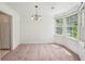 A bright dining room with a bay window and a decorative chandelier at 742 Redland Dr, Jonesboro, GA 30238