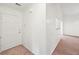Well-lit foyer featuring a solid front door, neutral walls, and carpeted flooring at 742 Redland Dr, Jonesboro, GA 30238
