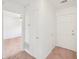 Hallway with carpet and white walls leading into a room and features a closet and front door at 742 Redland Dr, Jonesboro, GA 30238